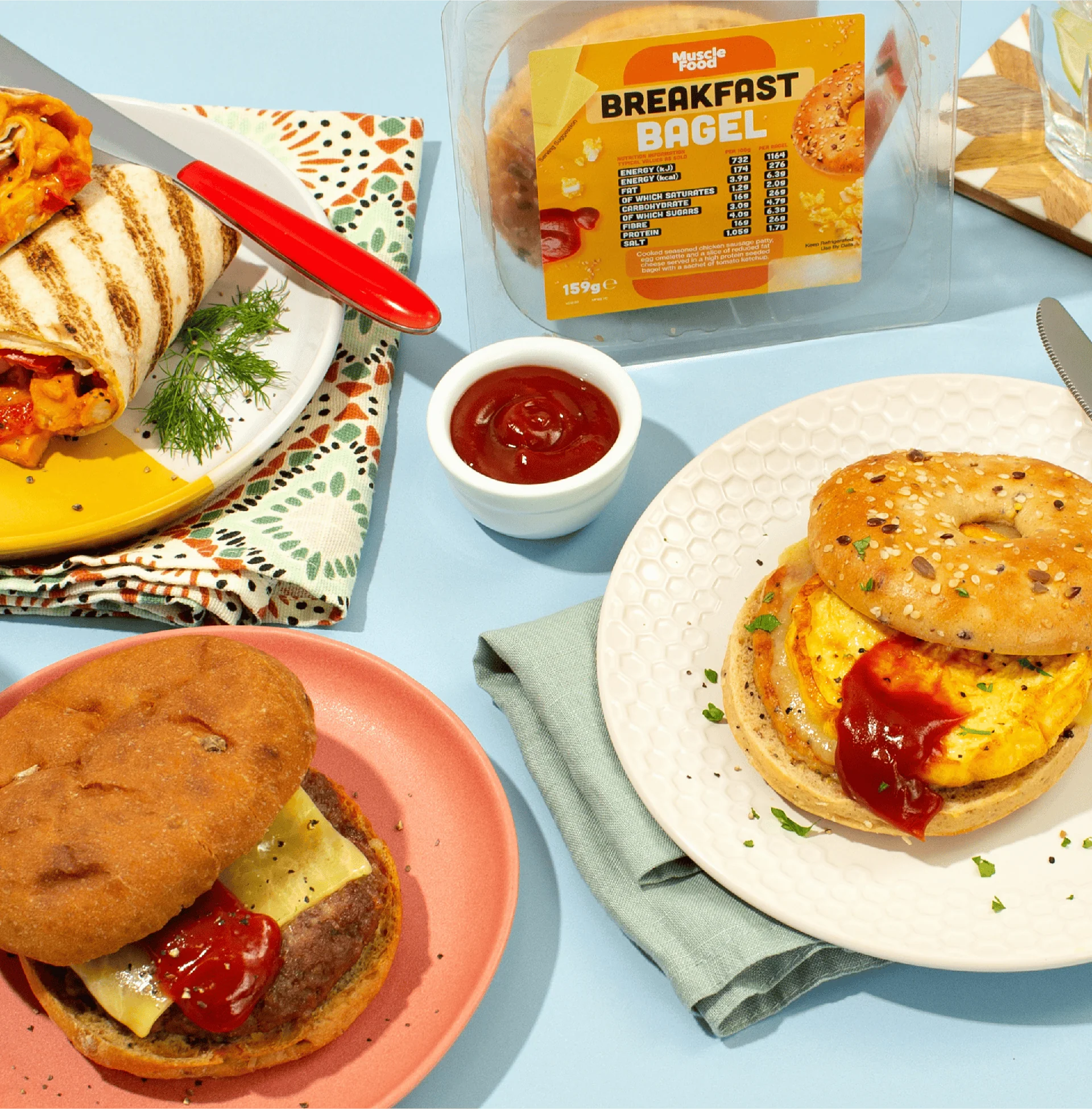Breakfast bagel packaging shown beside plated bagels and food styling